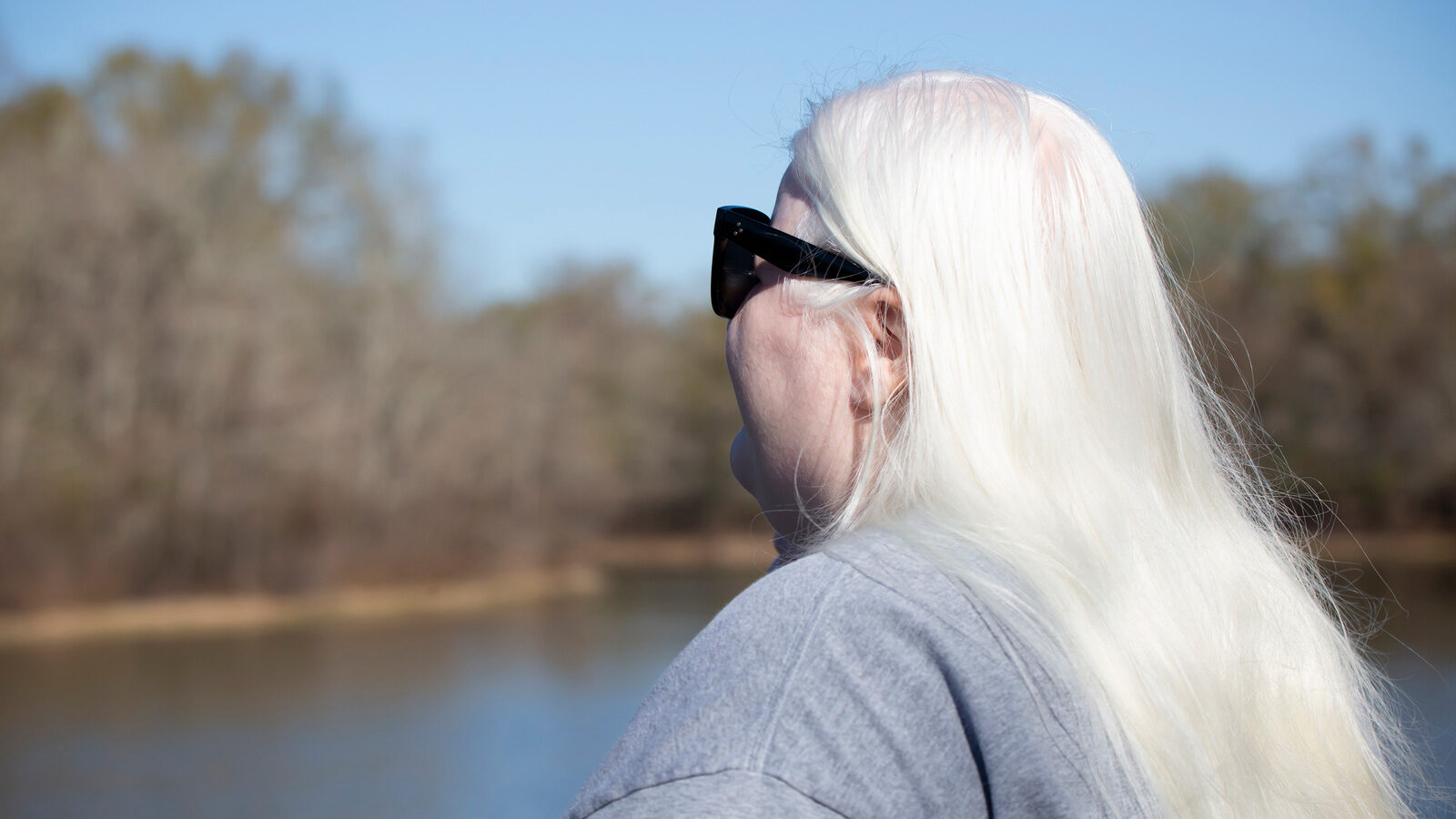 Ginny looking out on a lake through shades